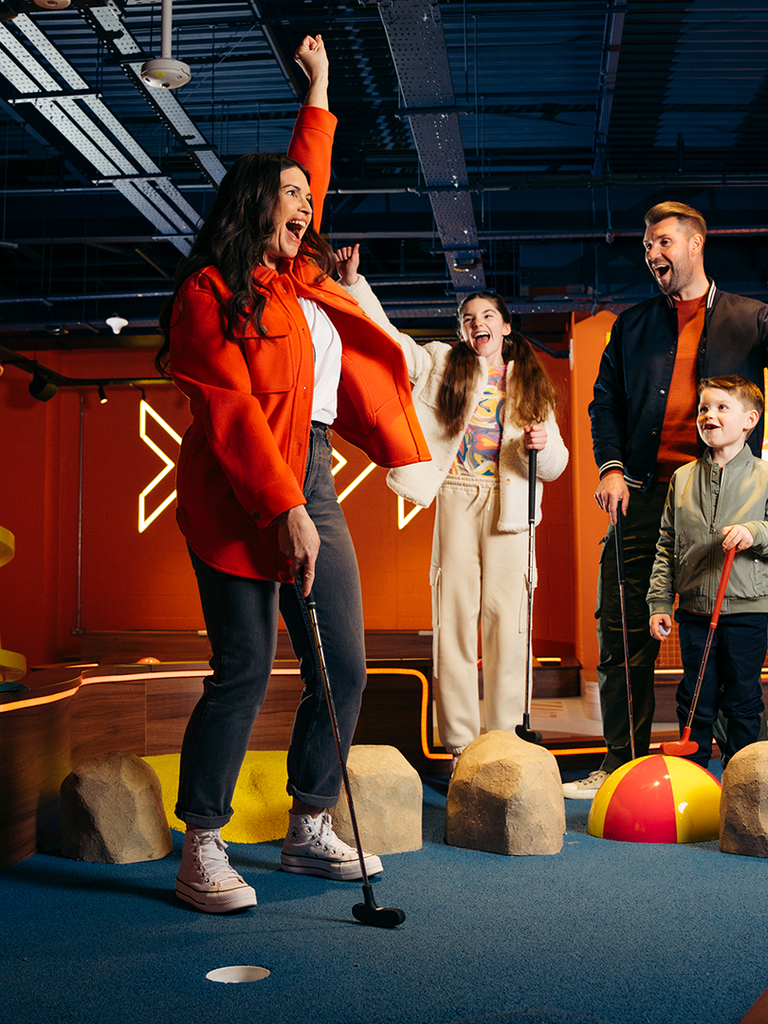 A family playing mini golf at a Hollywood Bowl Putt & Play centre